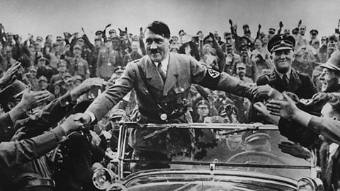 Hitler in a car, being mobbed by supporters