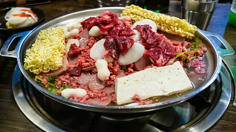 KrimKate/Getty Images Blending Korean flavours with American meats like Spam and hot dogs, budae-jjigae is thought to be the first Korean-American fusion dish (Credit: KrimKate/Getty Images)