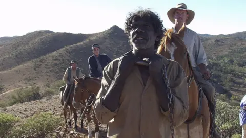 Getty Images David Gulpilil with other actors in a scene from The Tracker