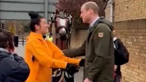 Prince William greeting charity walker Emma Webb