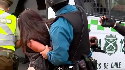 Woman stealing gun from guard