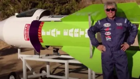 CBS Mike Hughes in front of his rocket