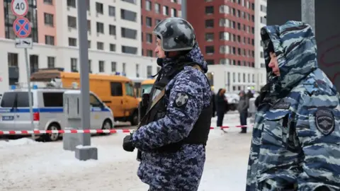 EPA Police officers in camouflage outfits stand guard near a scene of an explosion in Moscow