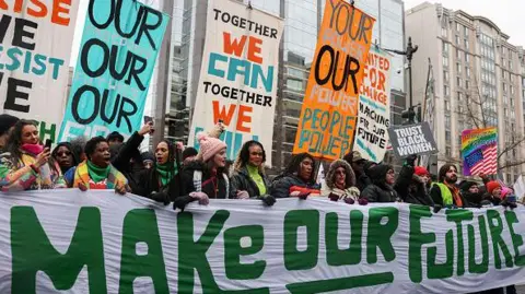 Getty Images Protesters hold a banner that reads "Make our Future"