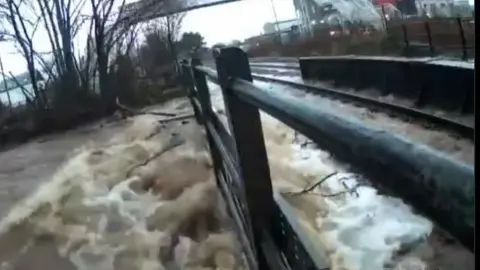 Raised water levels at a train track in Kingussie