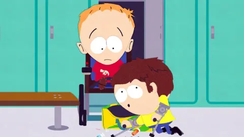 A still from an animation from South Park featuring Timmy, a ginger boy in a wheelchair wearing a red shirt and frowning, beside his best friend Jimmy, who has crutches and is surrounded by syringes