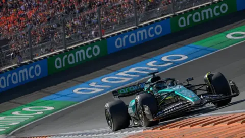 Aston Martin's Lance Stroll on track during the Netherlands Grand Prix with Aramco sponsorship visible on the barriers and his car