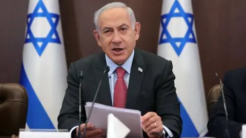 EPA Israeli Prime Minister Benjamin Netanyahu speaks at a weekly cabinet meeting in Jerusalem (19 March 2023)