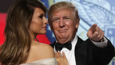 Donald Trump points at the camera while he dances with his wife Melania at the inaugural ball in 2017