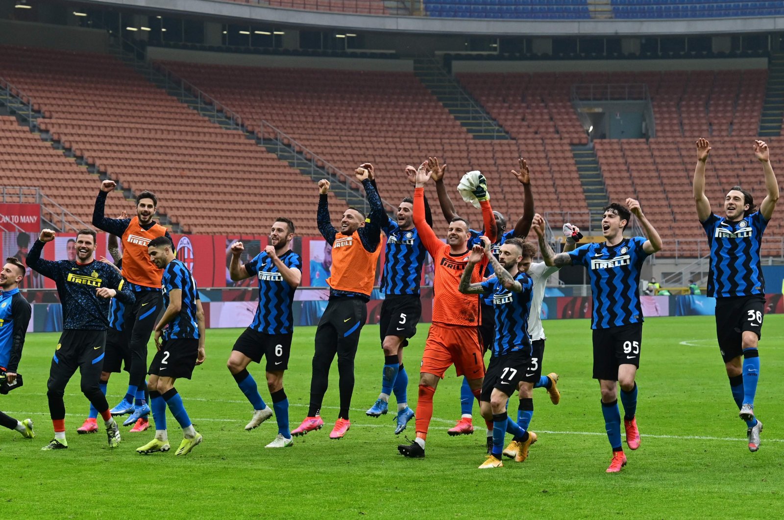 Inter players celebrate winning at the end of the Italian Serie A football match AC Milan vs Inter Milan at the San Siro stadium in Milan, Feb. 21, 2021. (AFP Photo)