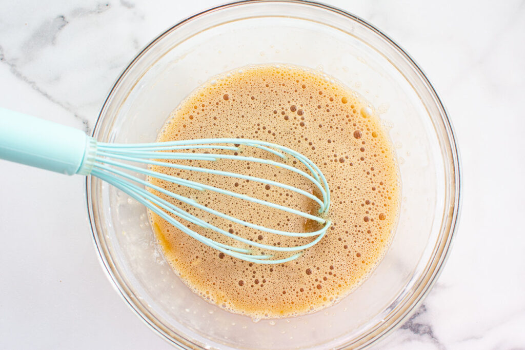 Whisking eggs, coconut oil and maple syrup. 