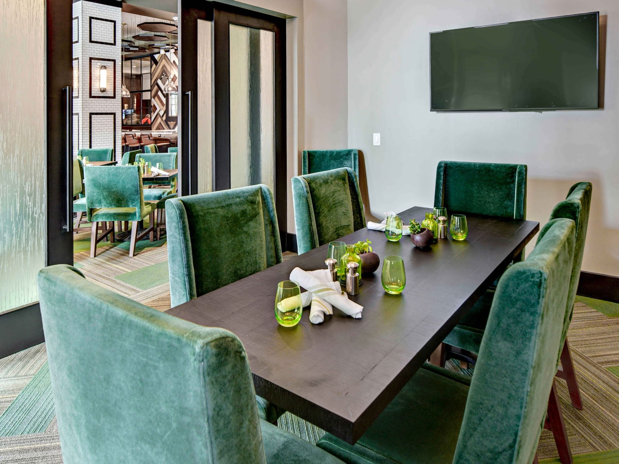 A dining area with a TV in the room at The Grove Hotel