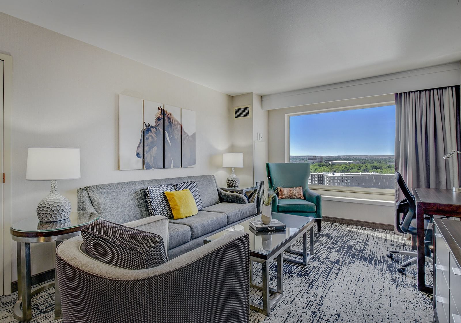 Living roomwith work desk and comfy chairs in Tower King Suite at The Grove Hotel