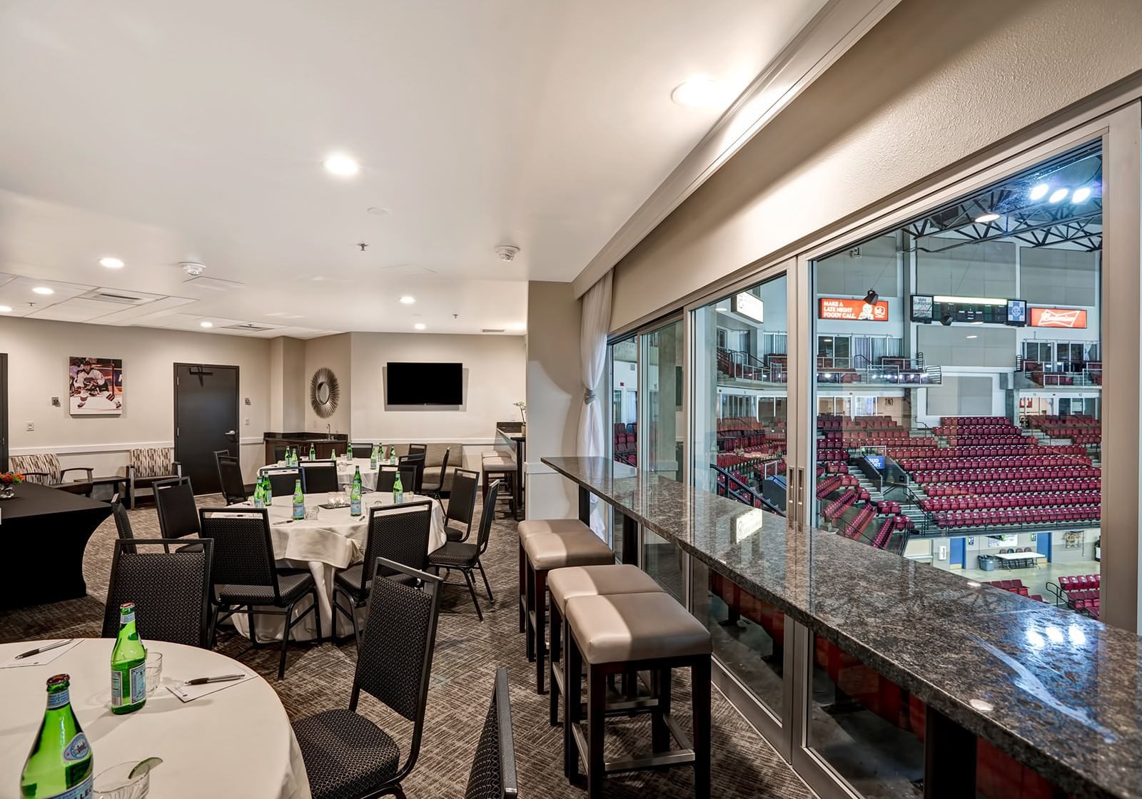 Tv, tables and chairs in a meeting room at The Grove Hotel