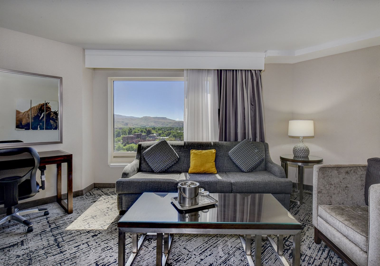 Couch, chair & a table in Tower King Suite at The Grove Hotel