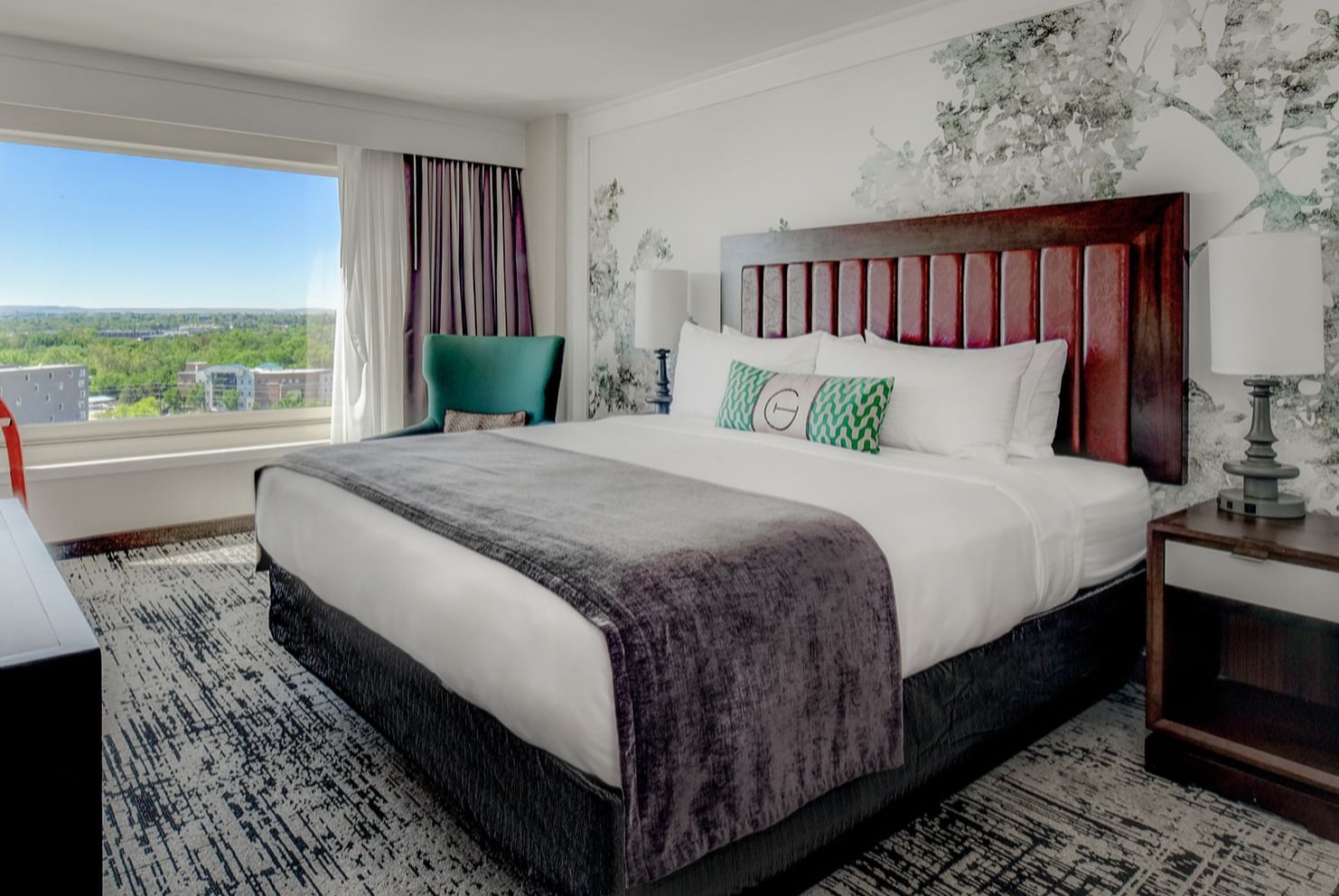 Bed & furniture in a guest room at The Grove Hotel