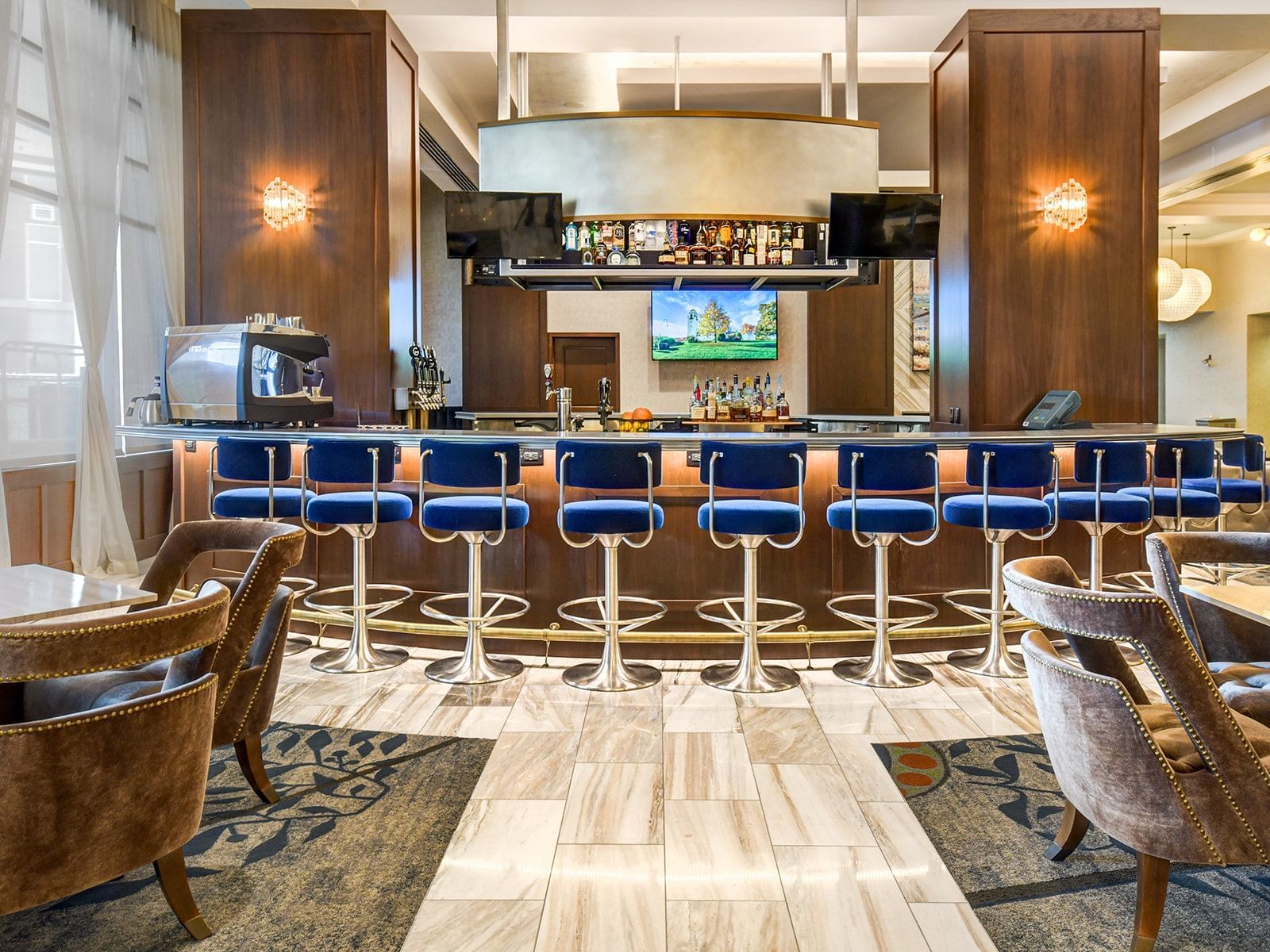 Bar counter with high chairs in The Bar at The Grove Hotel