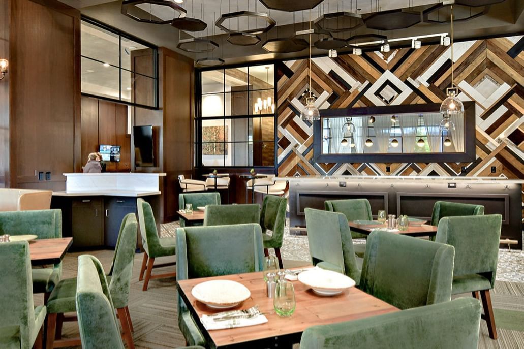 Interior of dining area in Trillium restaurant with dining tables at The Grove Hotel