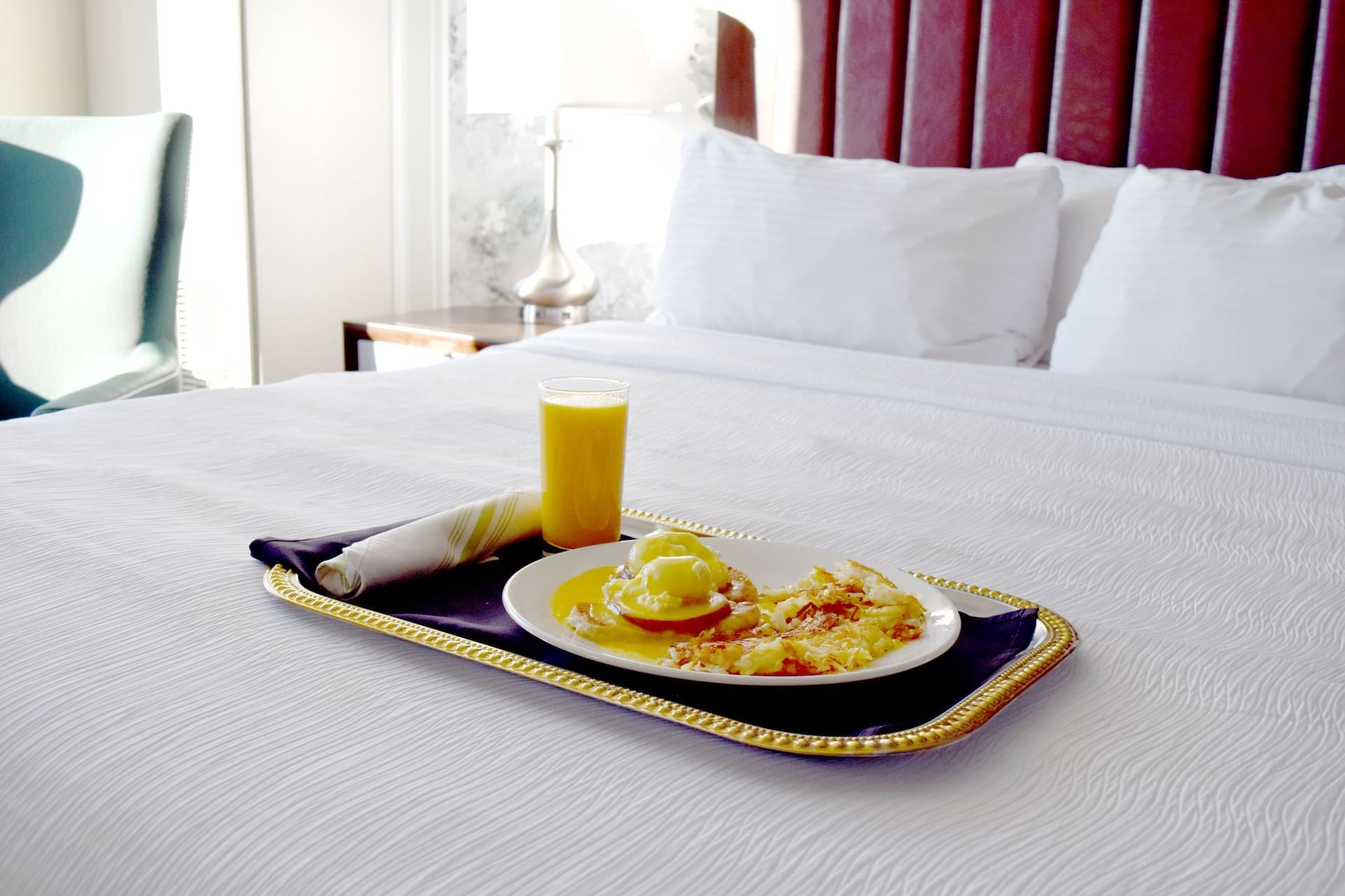 Breakfast served on a bed in a room at The Grove Hotel