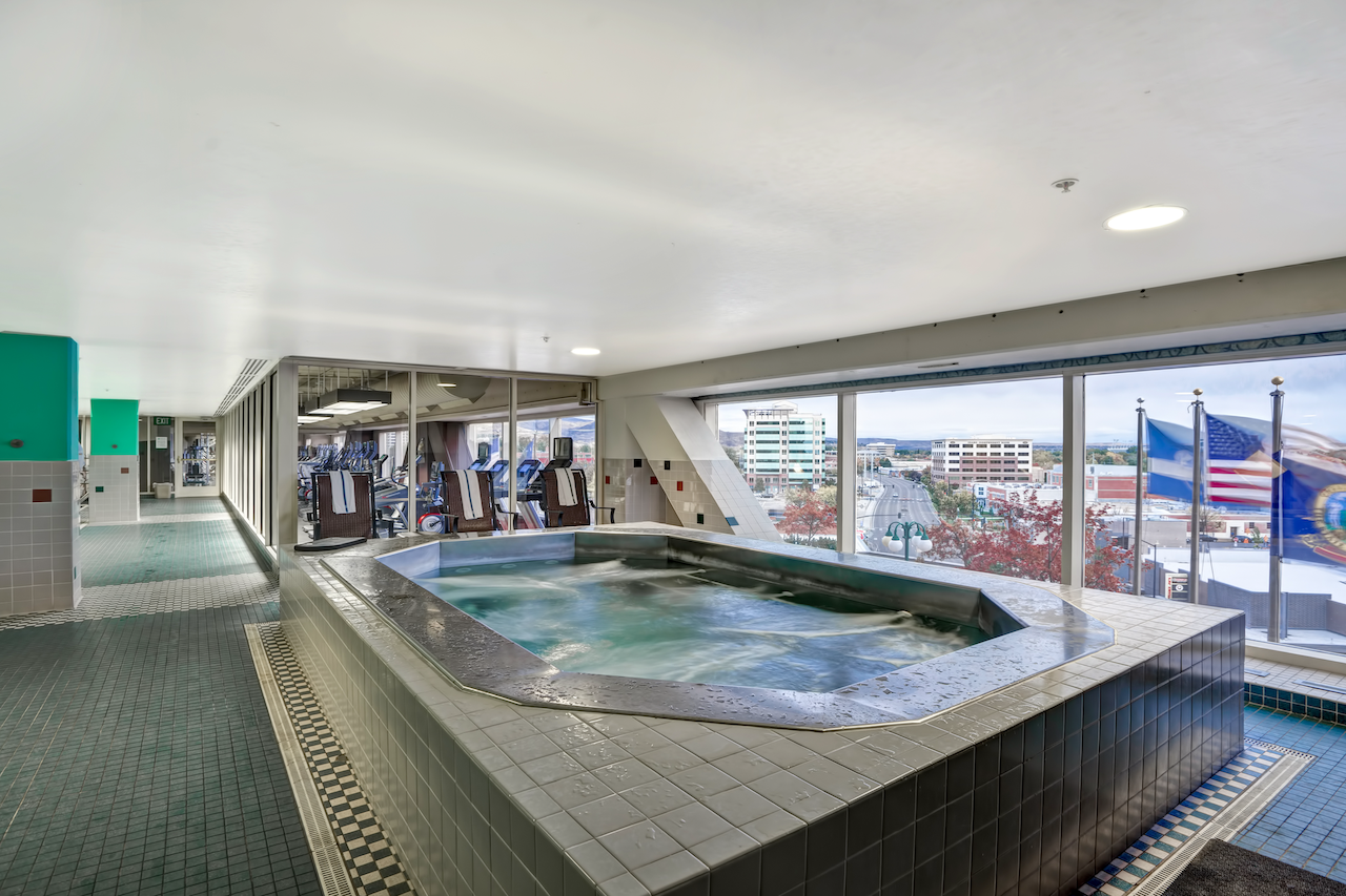 Interior of jacuzzi overlooking windows displaying flags at The Grove Hotel