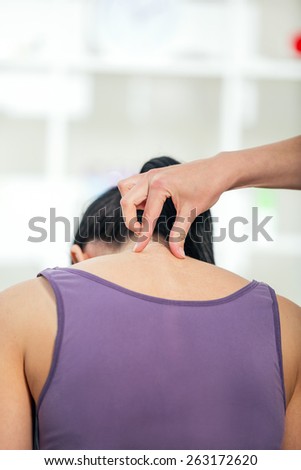 Chiropractor adjusting neck muscles