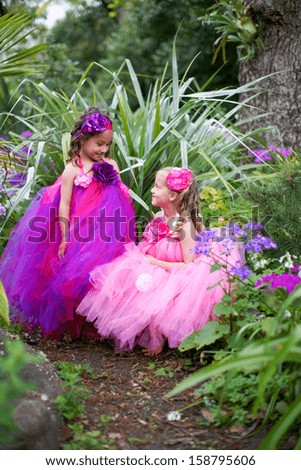 Pretty girls dressed as fairies in the garden.