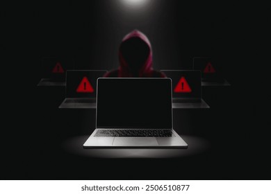 Crime and attack technology concept by hacker , Grey laptop with black blank screen and red hacker blurred in a black darkness background with lights shining down from above.