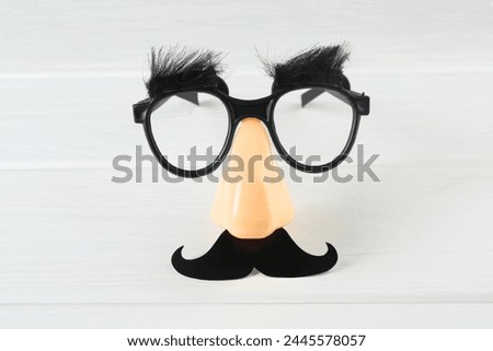 Similar – Funny face on paper bag with glasses and mustache