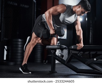 Man, weightlifting and dumbbell as bodybuilder or athlete in sports practice, training and gym. Male person, equipment and routine for challenge, muscle and wellness in workout, fitness and exercise