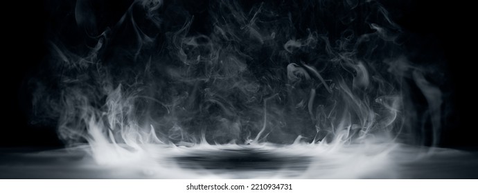 Real smoke exploding outwards with empty center. Dramatic smoke or fog effect for spooky Halloween background.