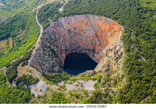 Red Lake (Croatian: Crveno jezero) is a collapse doline\
(collapse sinkhole) containing a karst lake close to Imotski,\
Croatia. It is 530 metres deep, thus it is the largest collapse\
doline in Europe. 