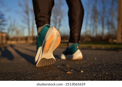 Runner's legs seen from behind with running shoes, ready for start