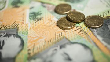 A generic picture of Australian money - $2 coins on top of $100 notes.