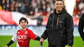 Kylian Mbappé tout sourire avec un enfant vêtu du maillot de Monaco en mars 2024