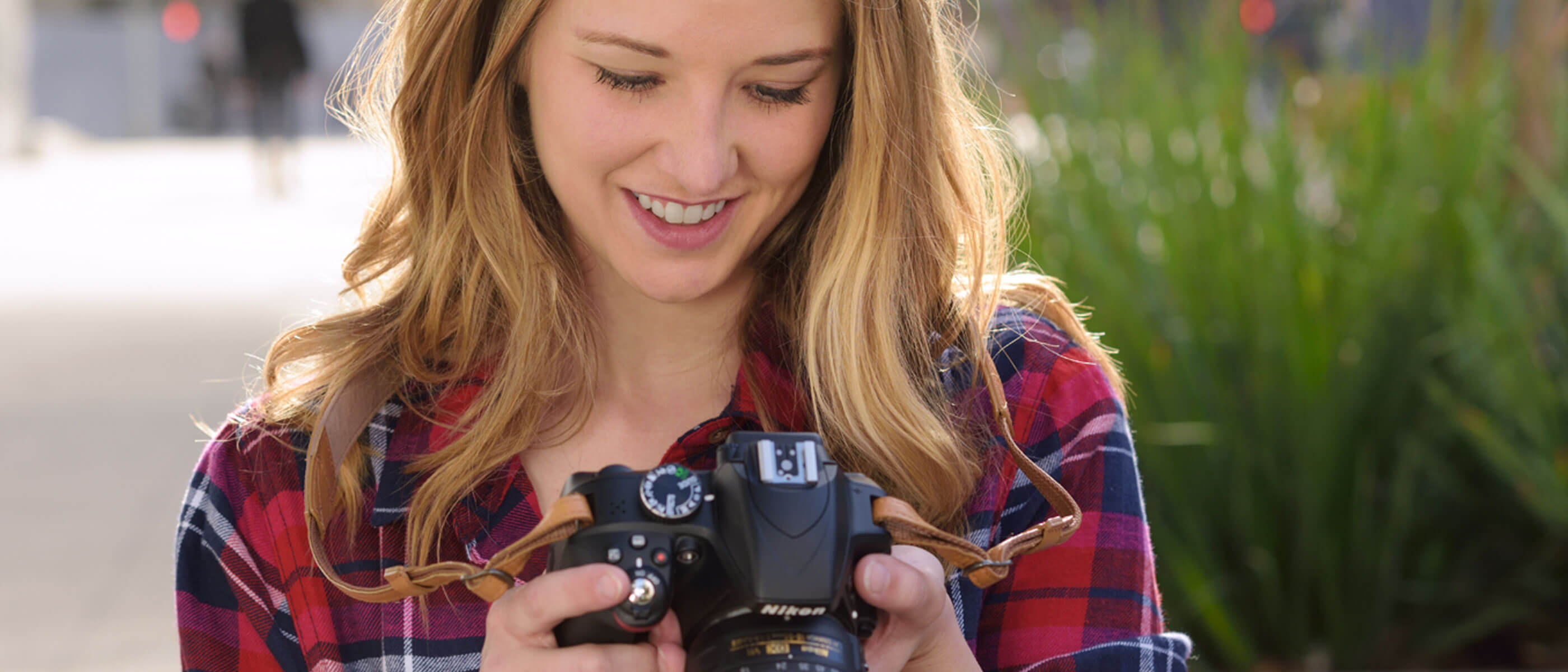 Woman looking at camera viewfinder