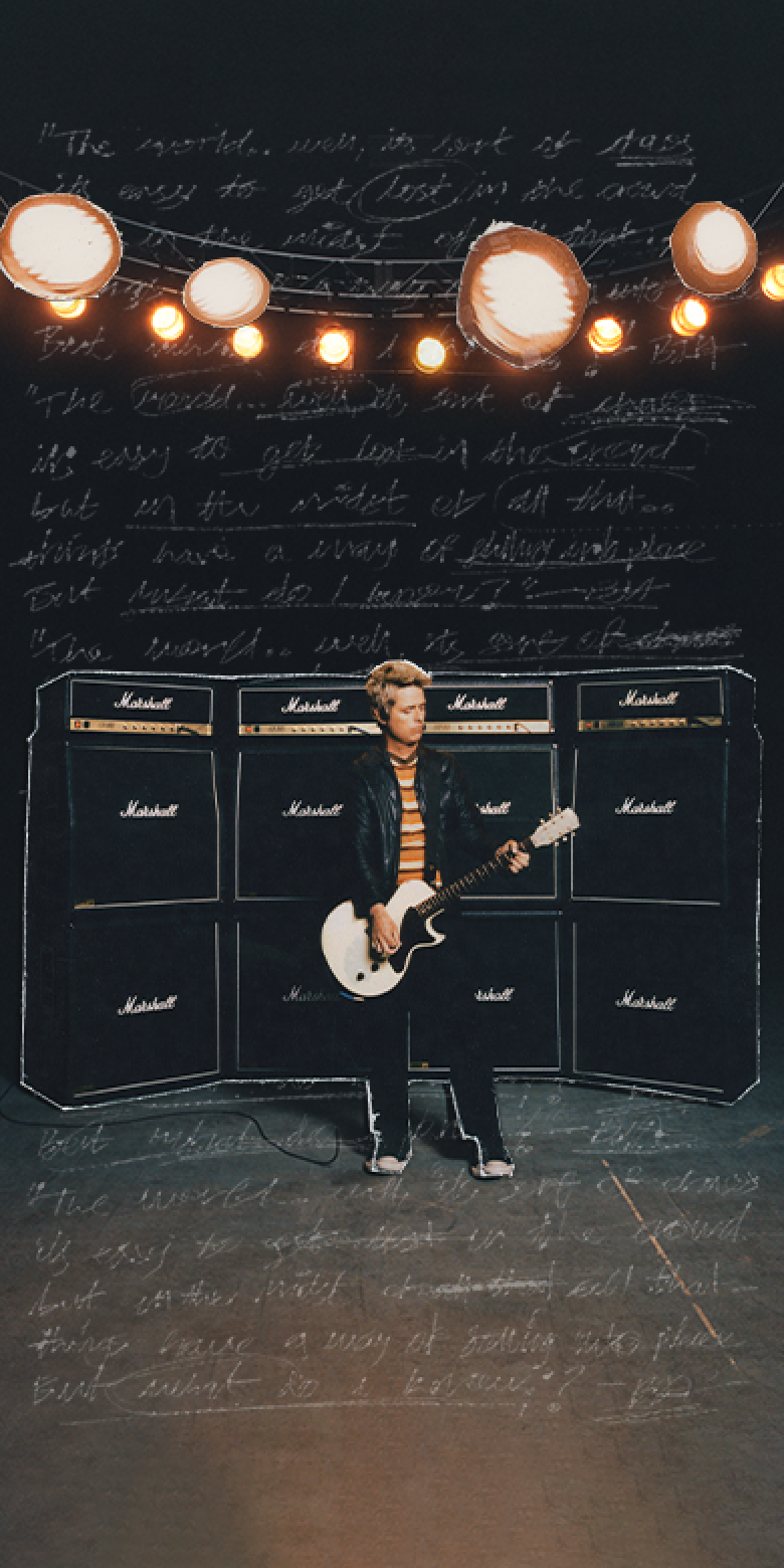 Billie Joe Armstrong standing in front of multiple Marshall amplifiers.