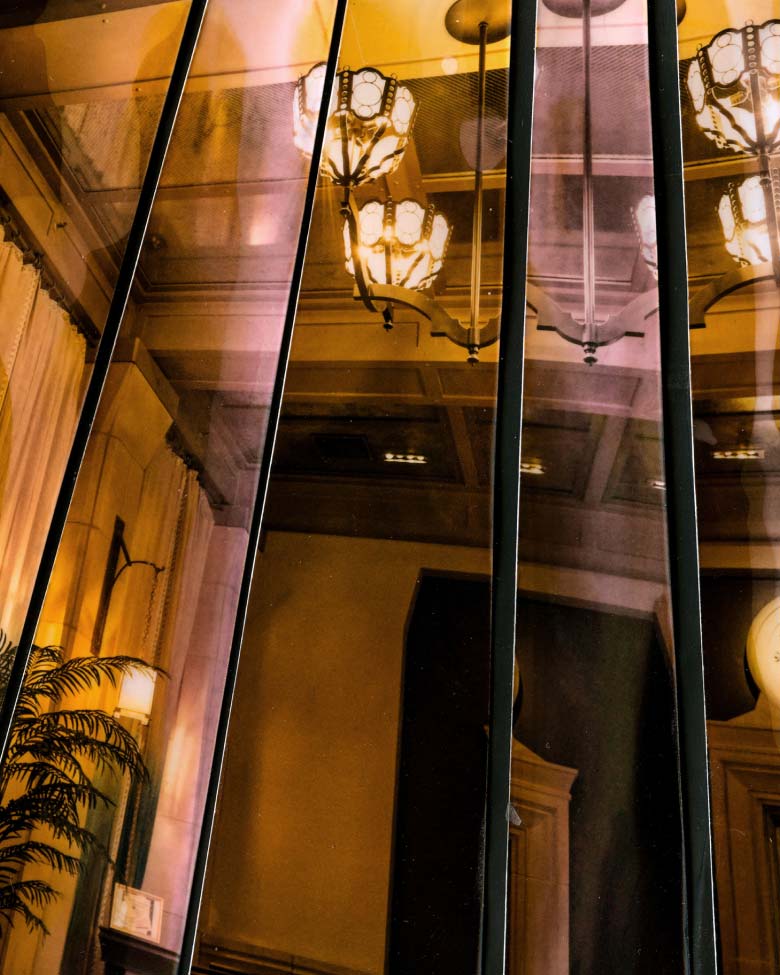 View of a chandelier in an art deco style hotel reception.