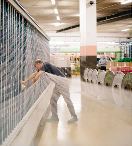 Image of Parachute factory worker threading fabric