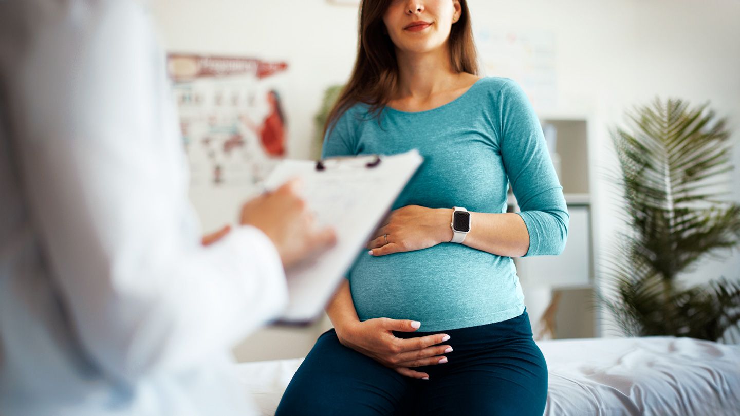 pregnant woman talking to doctor