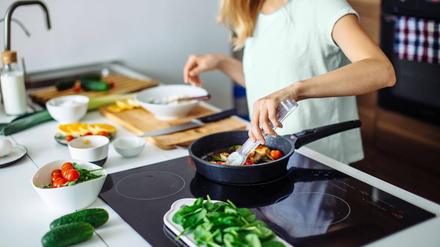 woman cooking at home in kitchen healthy food