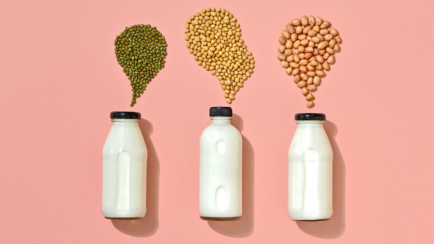 alternative milk bottles on pink legumes and pulses