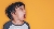 A young boy is screaming on a yellow background