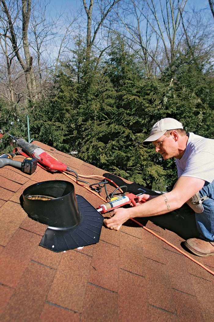 Once all the obstructions are out of the way, slip the flashing up under the shingles. Caulk under the top edge as a precaution against leakage, but don’t caulk the bottom.