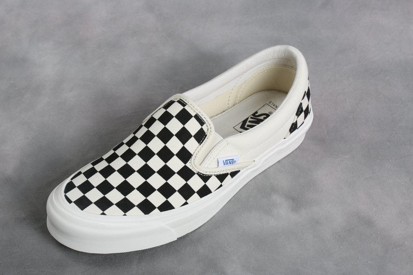 black and white slip on vans