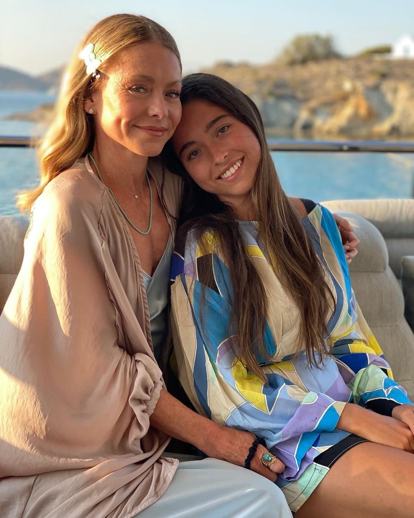 kelly ripa and daughter lola consuelos posing on a boat