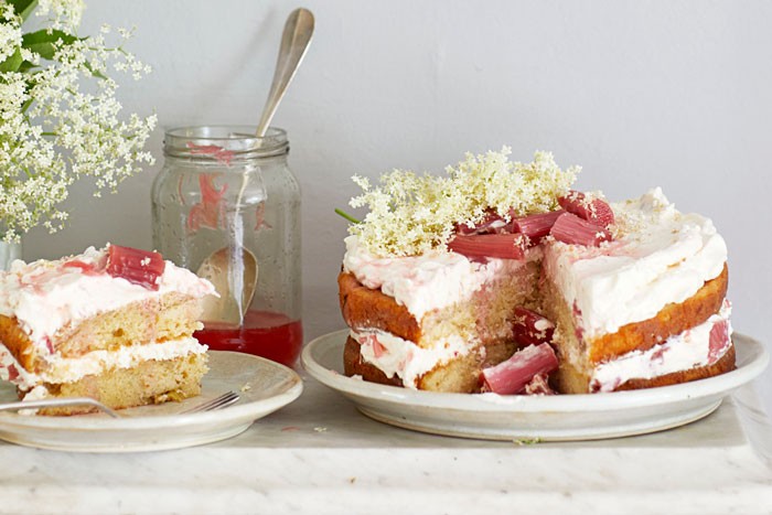 Whole rhubarb and elderflower cake topped with elderflower