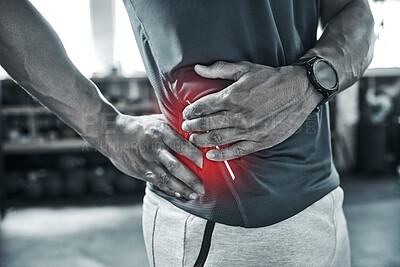 Tight hips are no good for pain. Bodybuilder with hip pain. Muscle pain is common when bodybuilding. Closeup of hand of a trainer touching his waist in pain at the gym