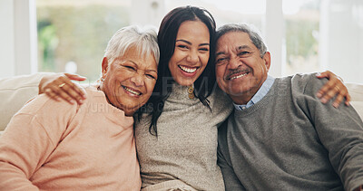 Hug, portrait and smile of old people with daughter on sofa in living room of home for bonding or visit. Family, love and support with happy family embracing in apartment together for wellness