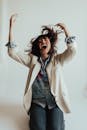 Woman in White Coat and Blue Denim Shorts