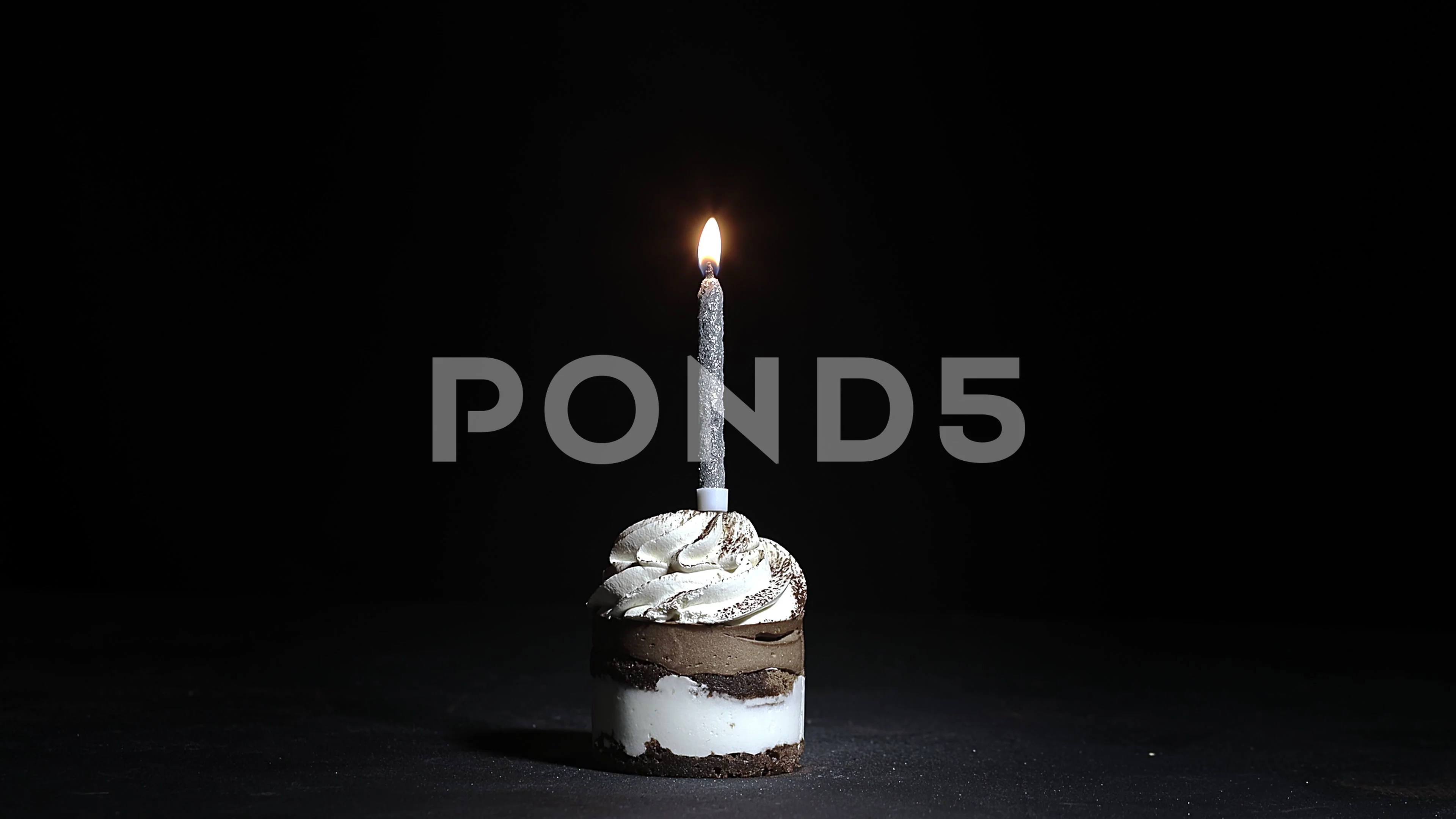 Birthday Cake with a candle on a black b... | Stock Video | Pond5